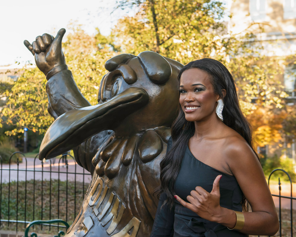 Carlisle is posed next to the Cocky statue for senior graduation photos on the University of South Carolina campus.