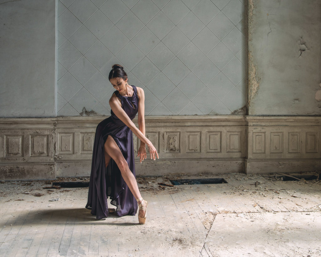 Ballet dancer Anna poses in a purple dress.