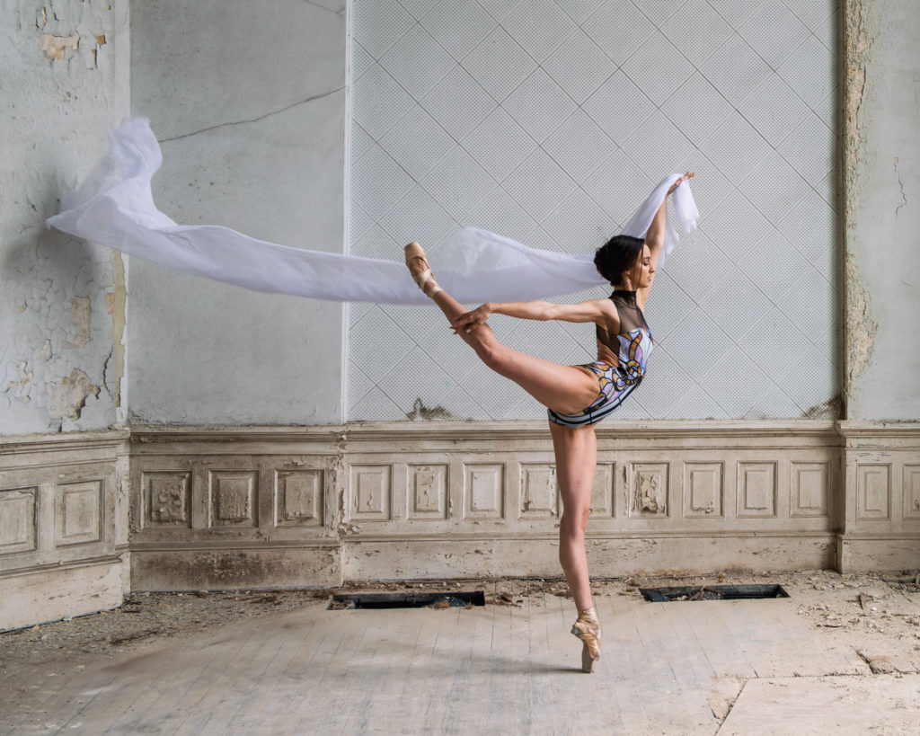 Dancer Anna Porter poses for ballet photography with a length of white chiffon fabric.