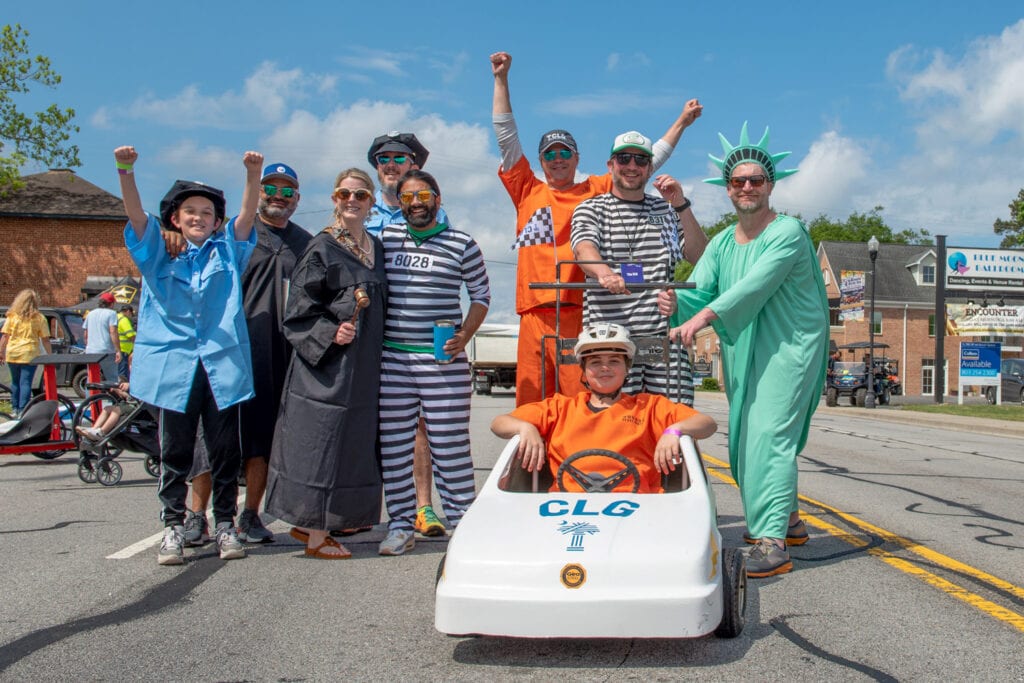 A costumed racing team poses at the top of Meeting Street for Kinetic Derby Day in West Columbia.