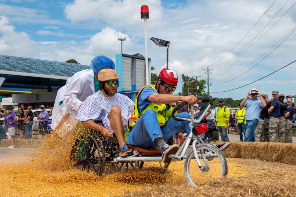 A racing team crashes into corn kernels at the bottom of Meeting Street.