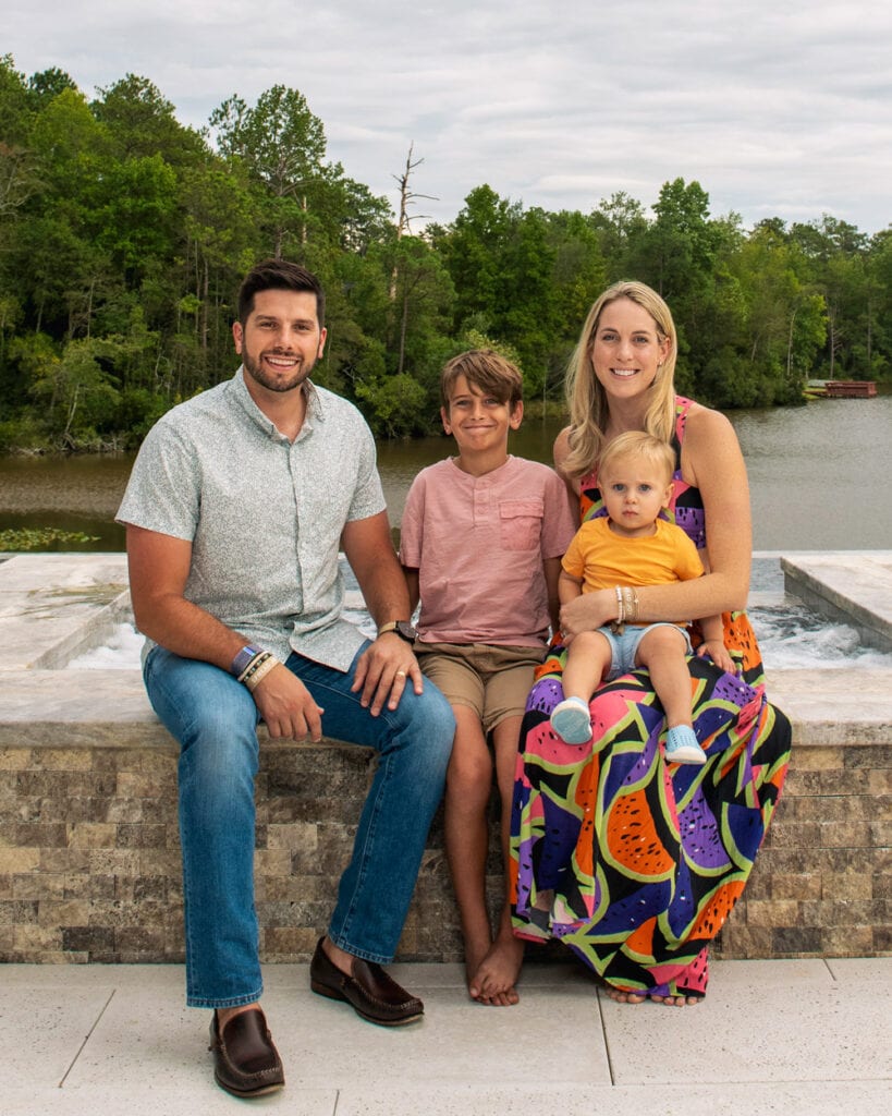 This is a family portrait taken in northeast Columbia, SC in front of a lake.